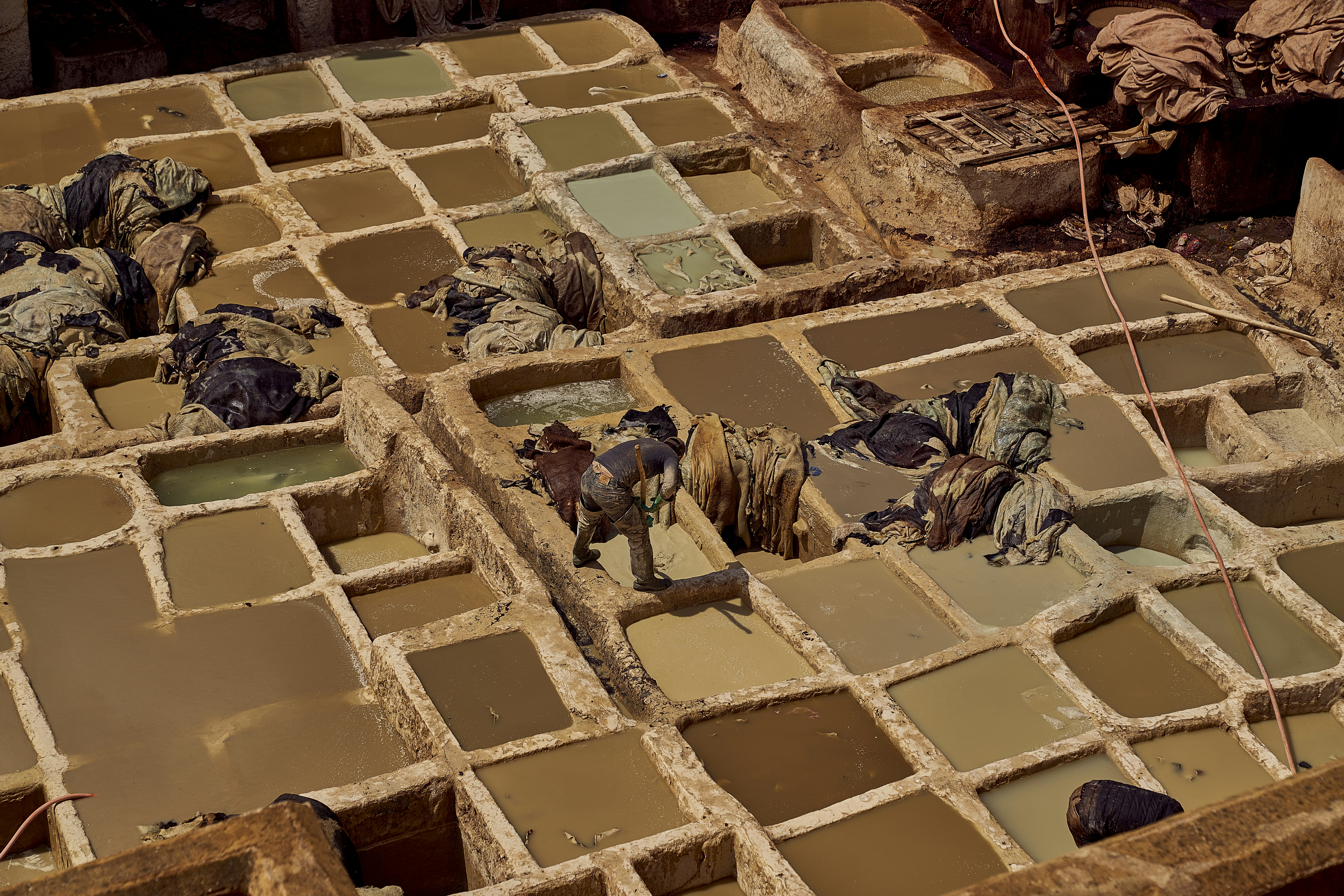 A pile of cement blocks sitting on top of a pile of dirt