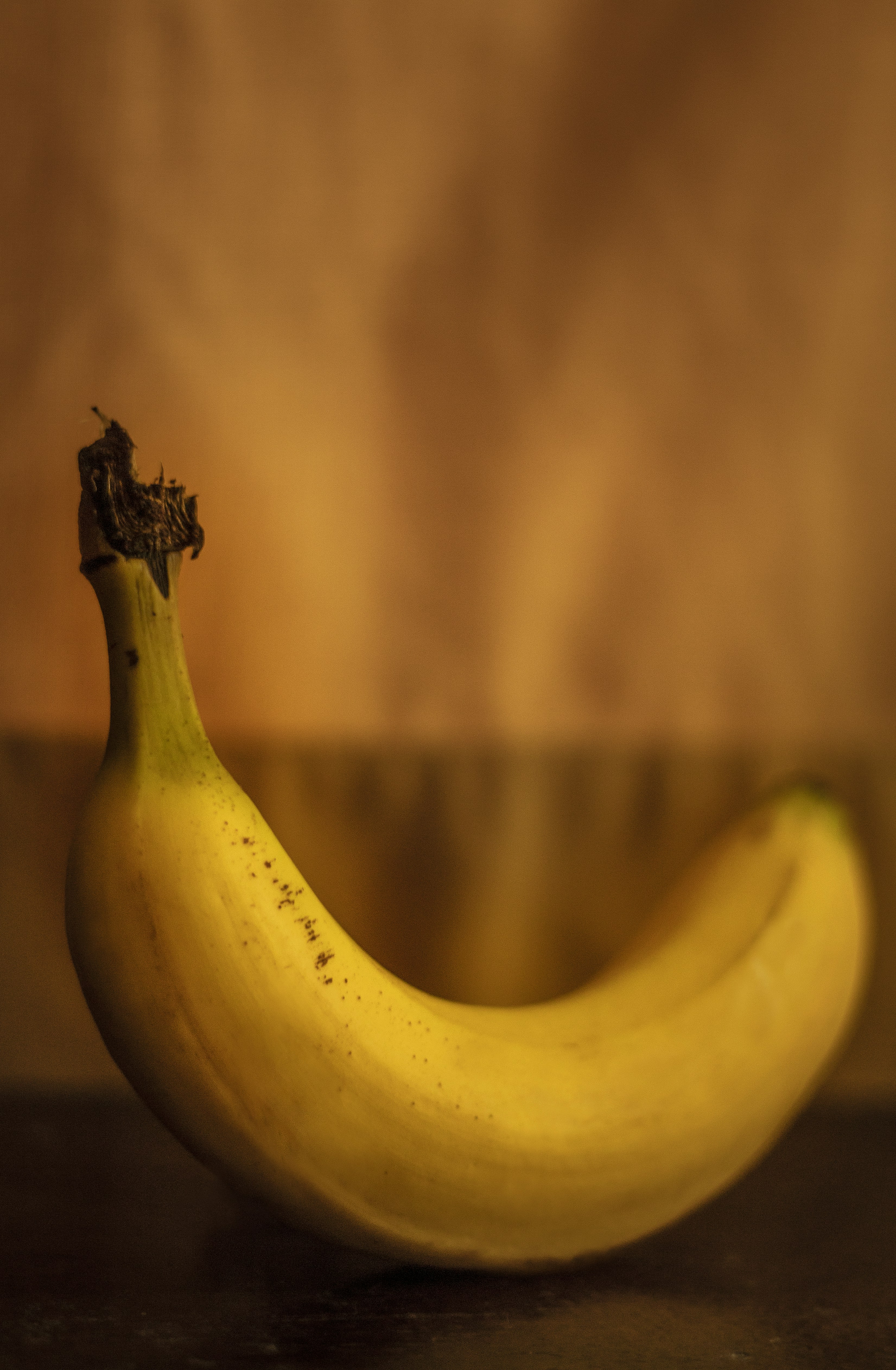 a ripe banana sitting on top of a wooden table border
