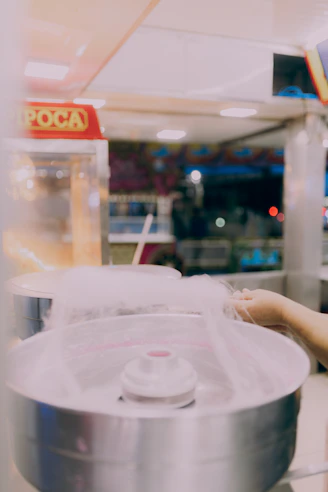 A woman is touching a machine in a store