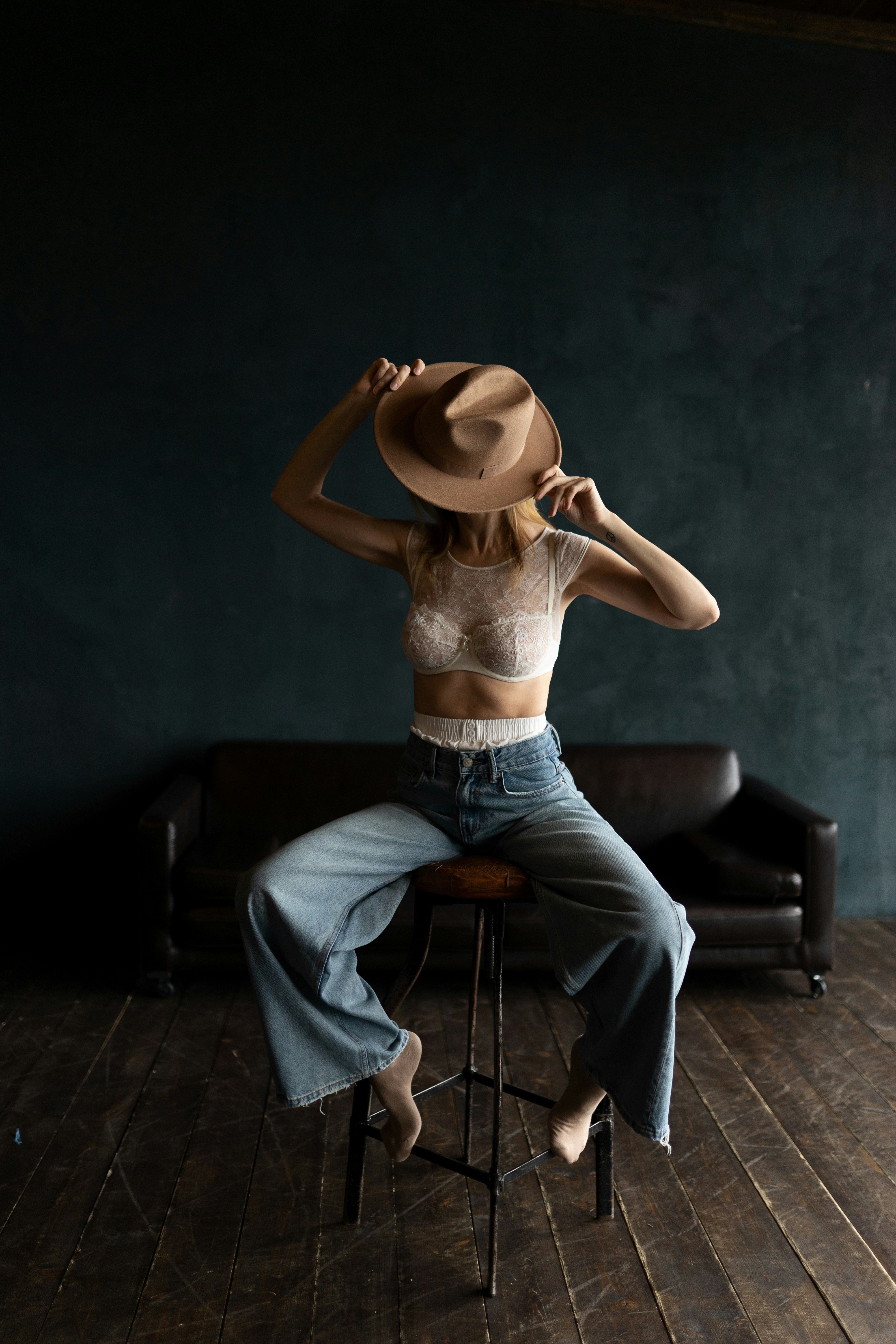 A woman sitting on a chair with a hat on her head