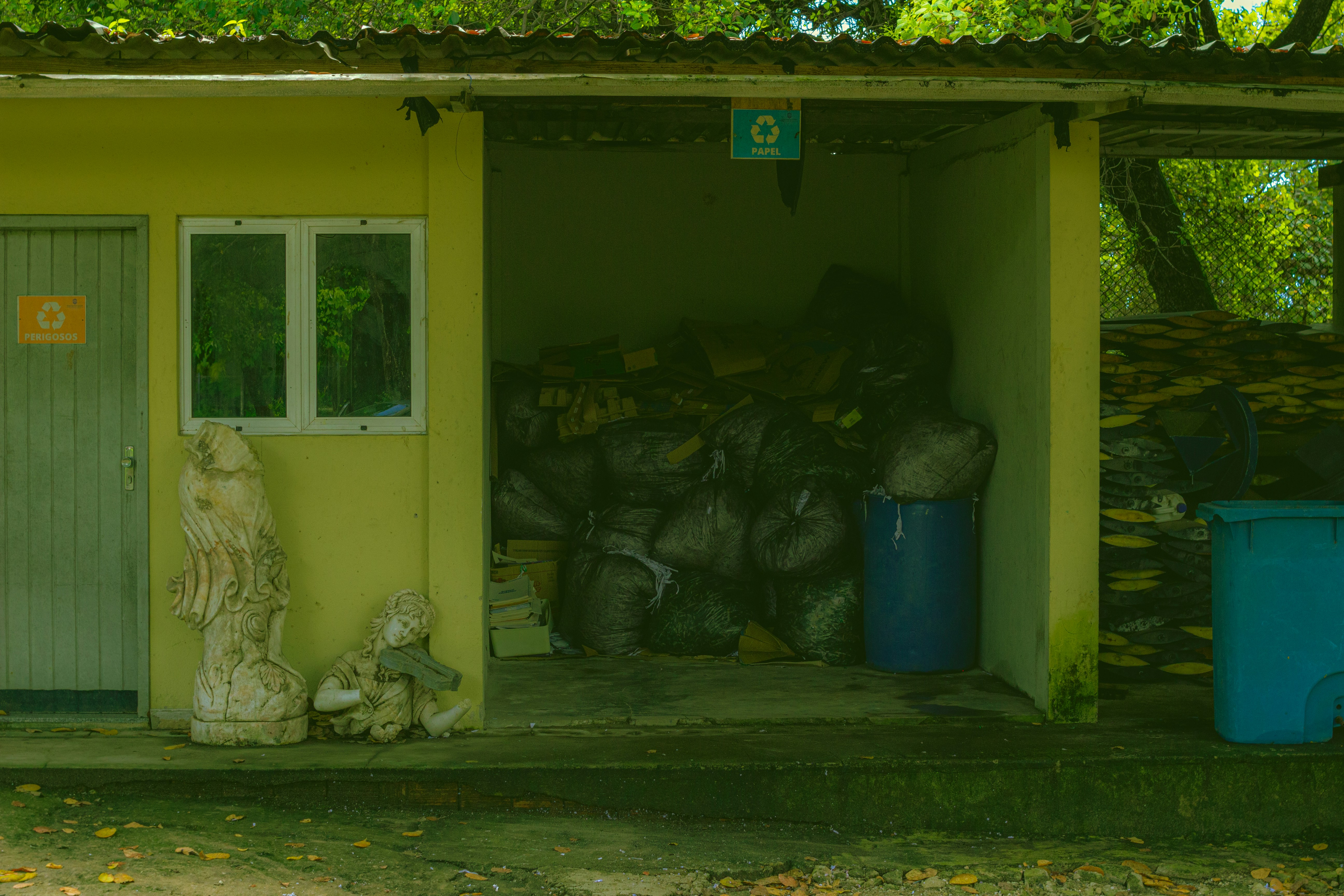 A small yellow building with a door and windows