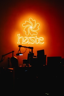 A neon sign is lit up in the dark