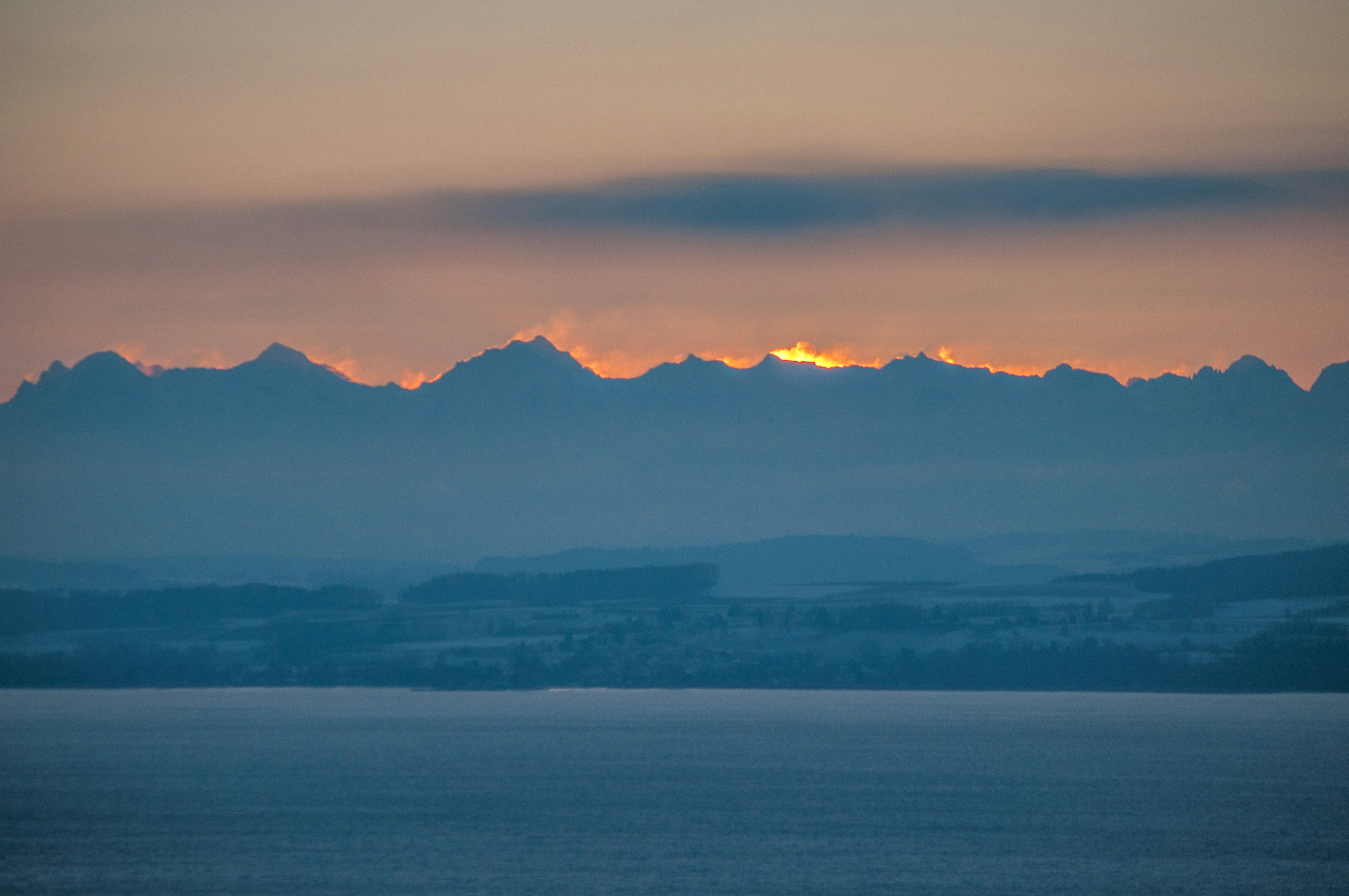 A large body of water with mountains in the background