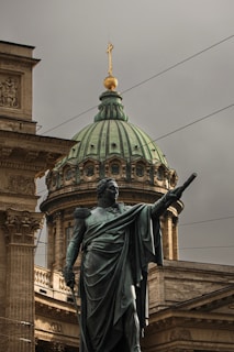 A statue of a man holding a gun in front of a building