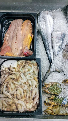 A variety of seafood is displayed on ice