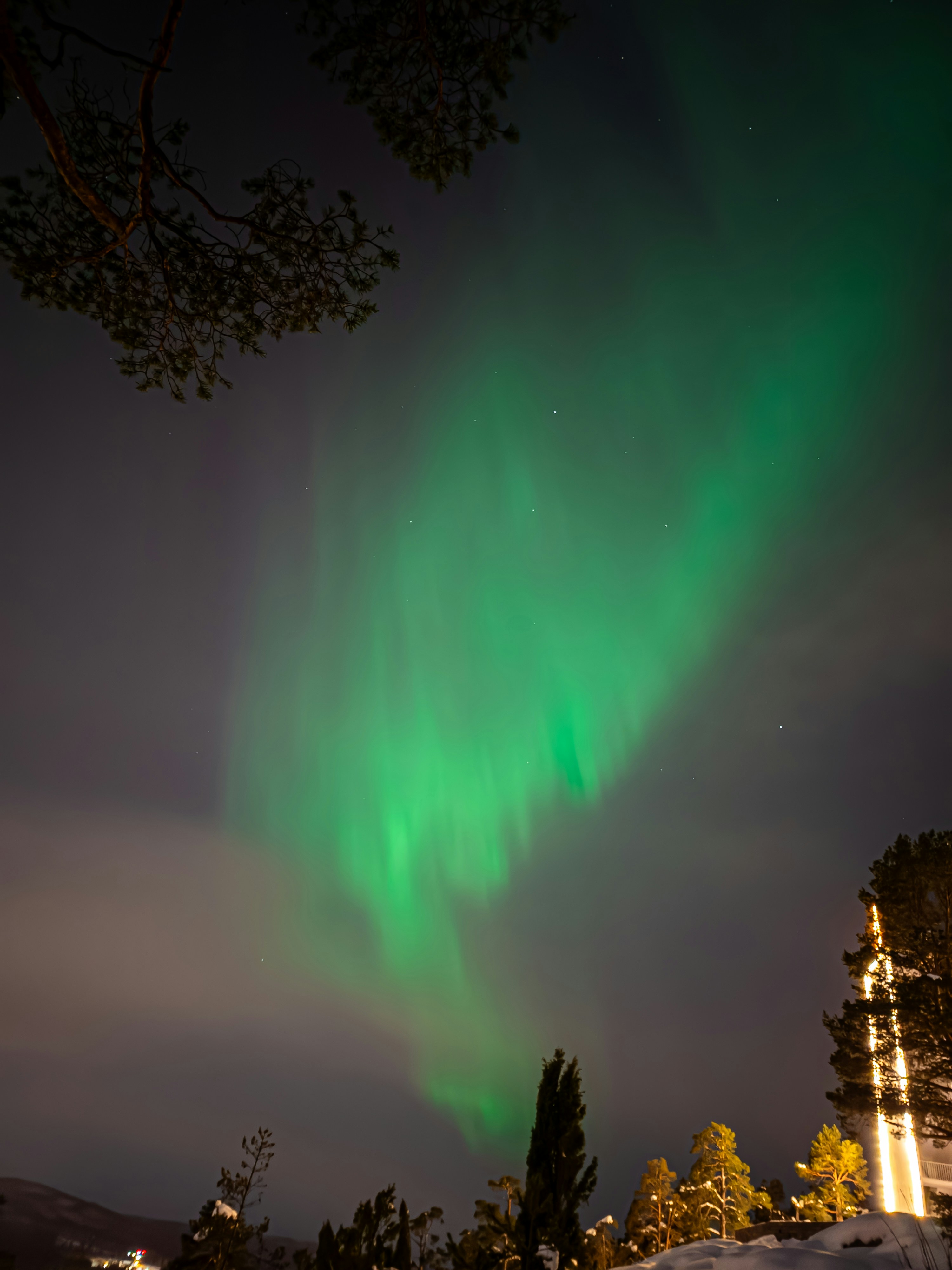 A bright green aurora bore in the night sky