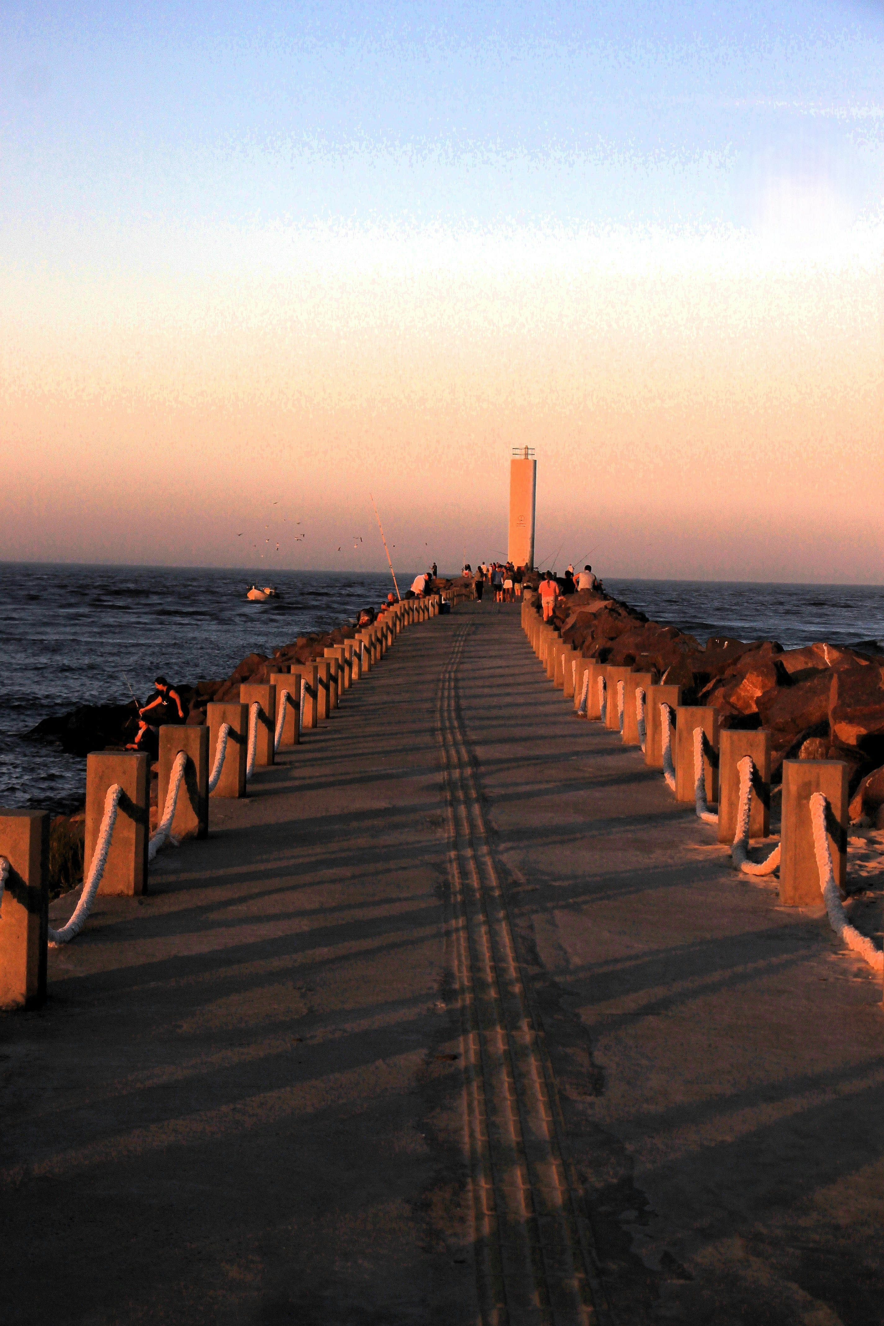 A long pier next to a body of water photo – Free Water Image on Unsplash