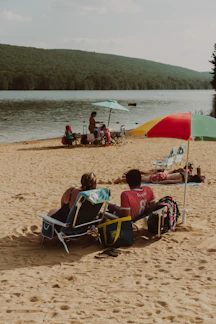 Sandy lake beach with picnic area at Rhea Springs Recreation Area
