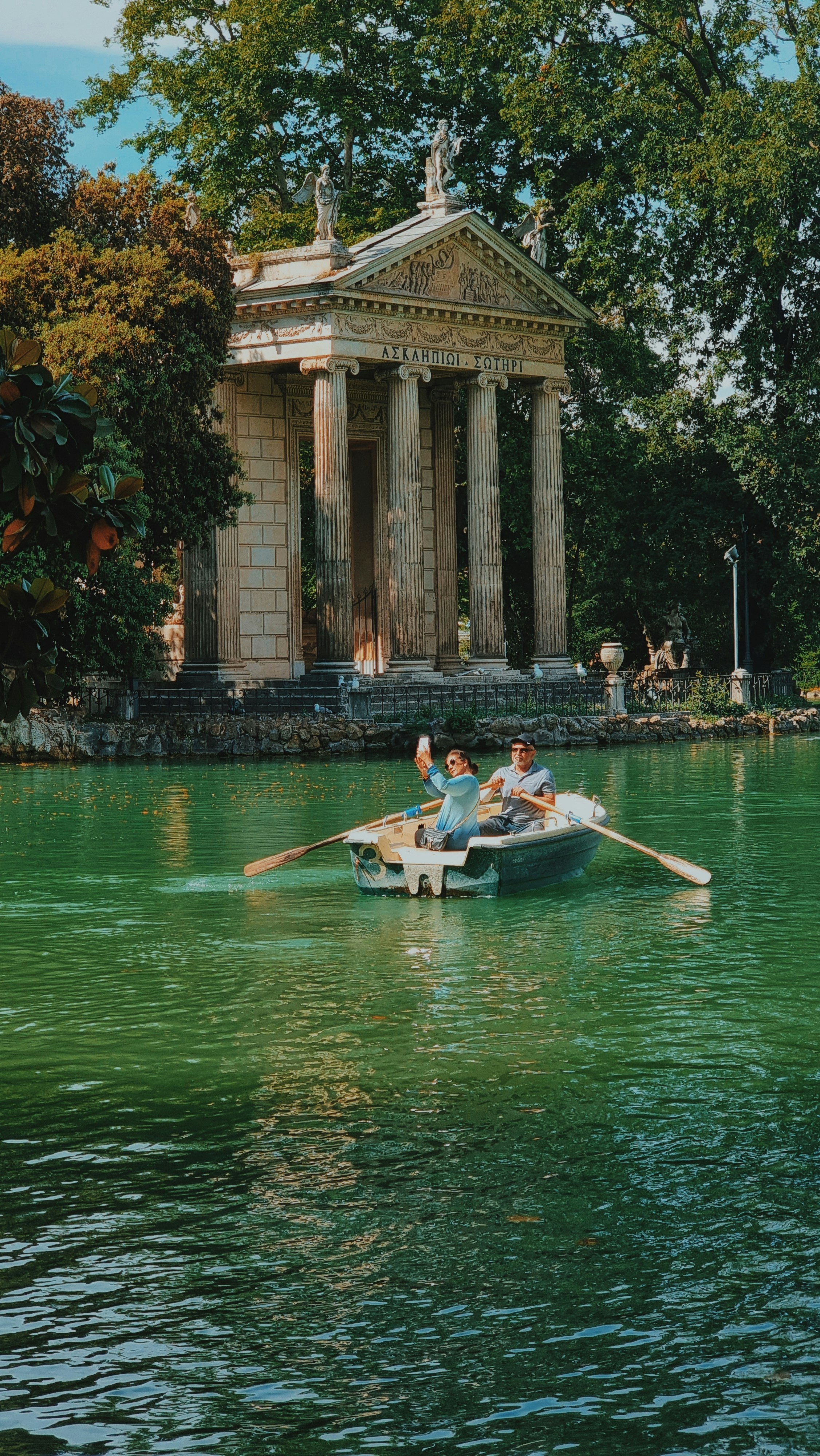 A couple of people in a boat on a body of water