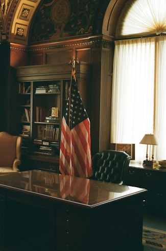 A desk with an american flag on top of it