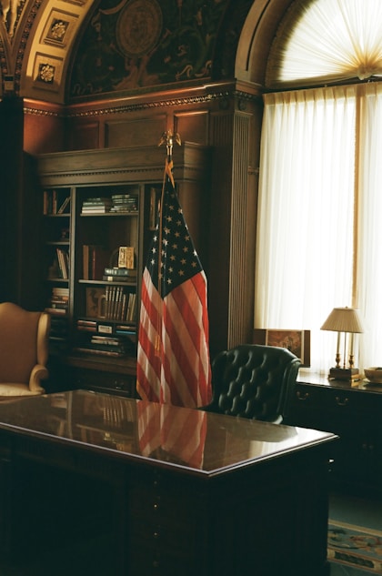 A desk with an american flag on top of it