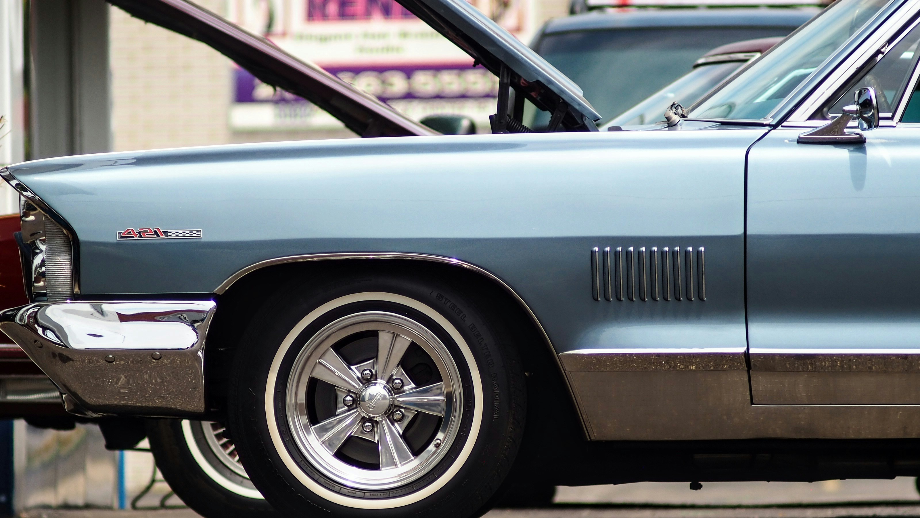 A blue car parked on the side of the road