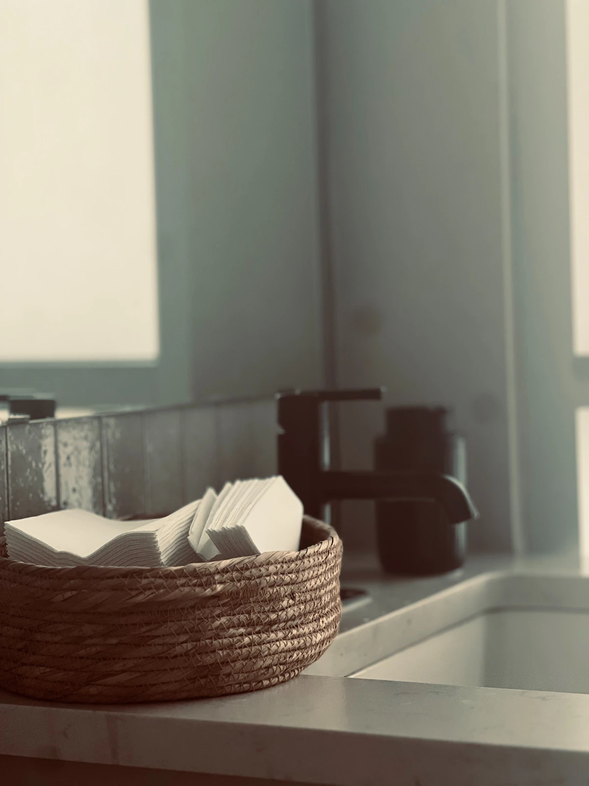 Small basket holding kitchen paper and letters away from the counter