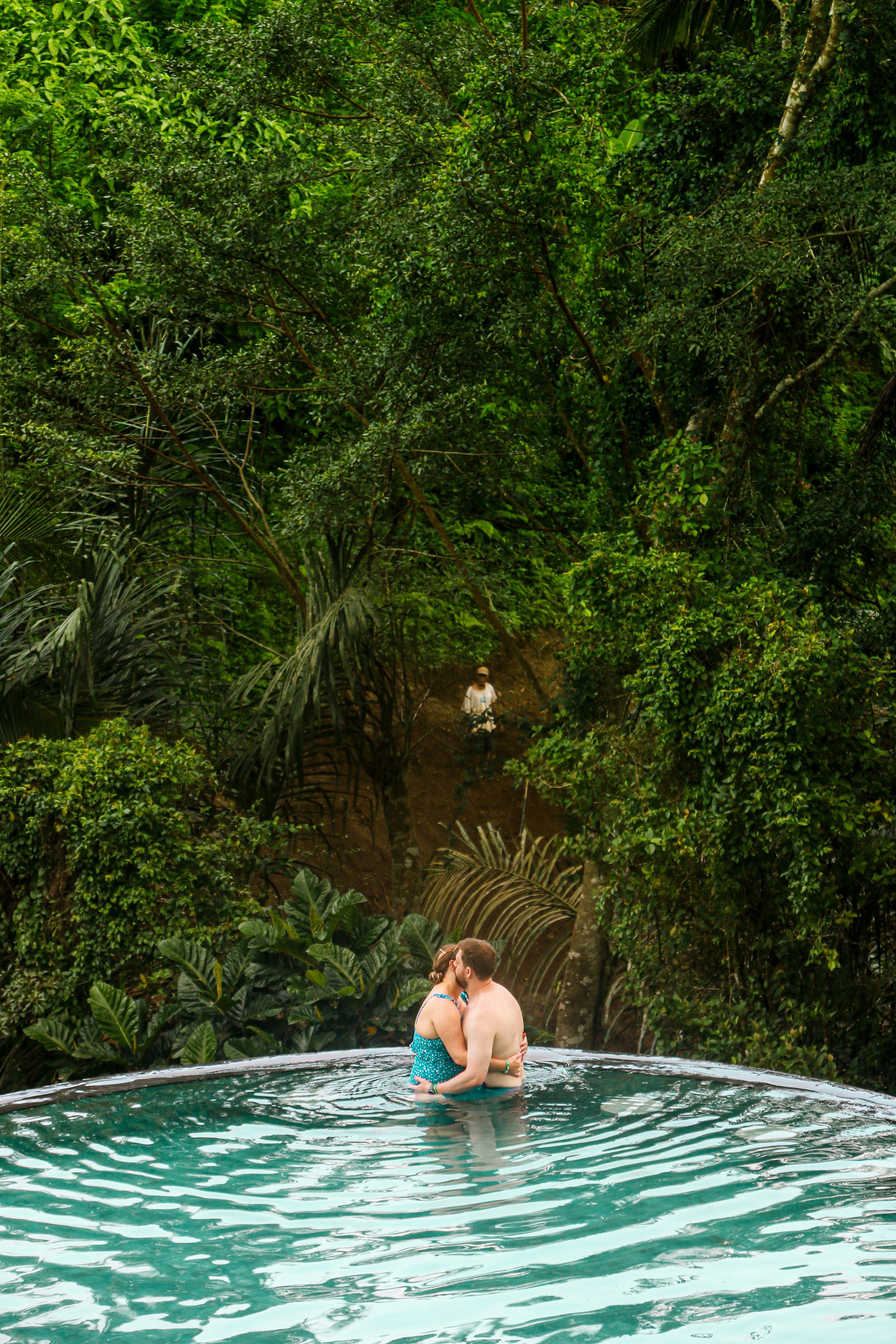 A person in a pool surrounded by trees