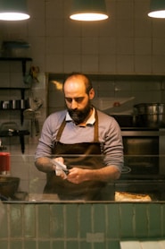 A man standing in a kitchen preparing food