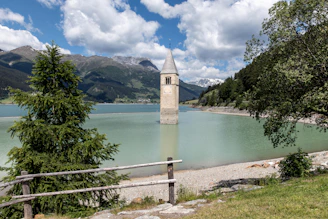 A large body of water with a clock tower in the background