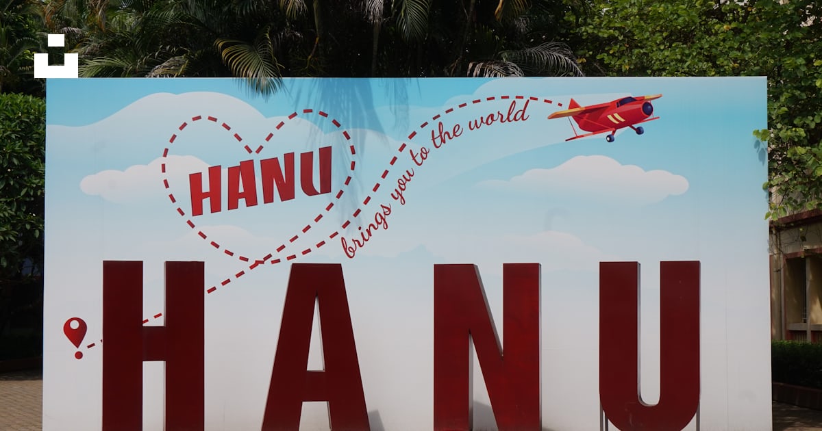 A sign that says hanu with a plane flying over it photo – Free Logo ...