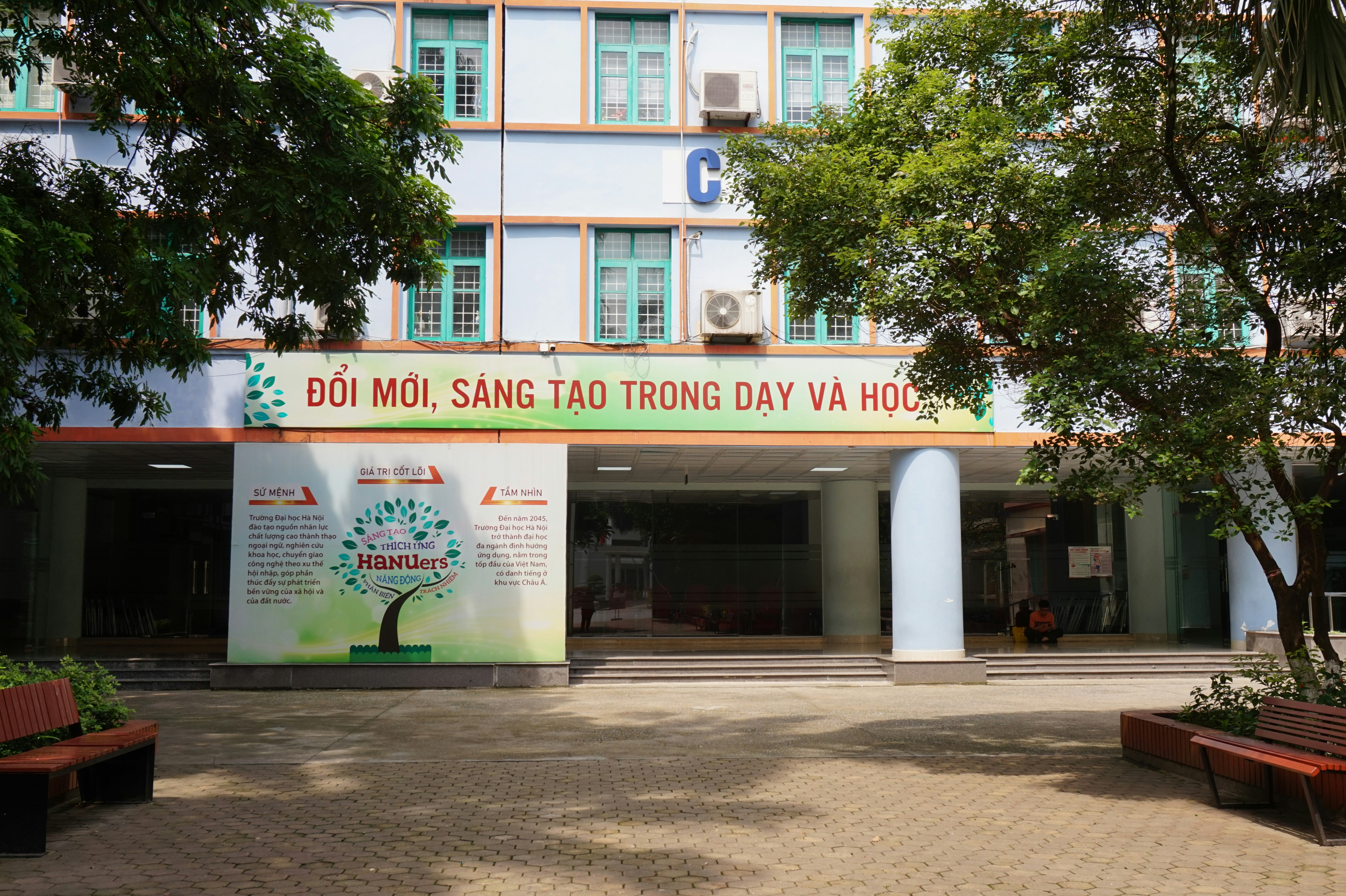 The front of a building with benches in front of it