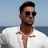 A man in a white shirt and sunglasses