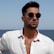 A man in a white shirt and sunglasses