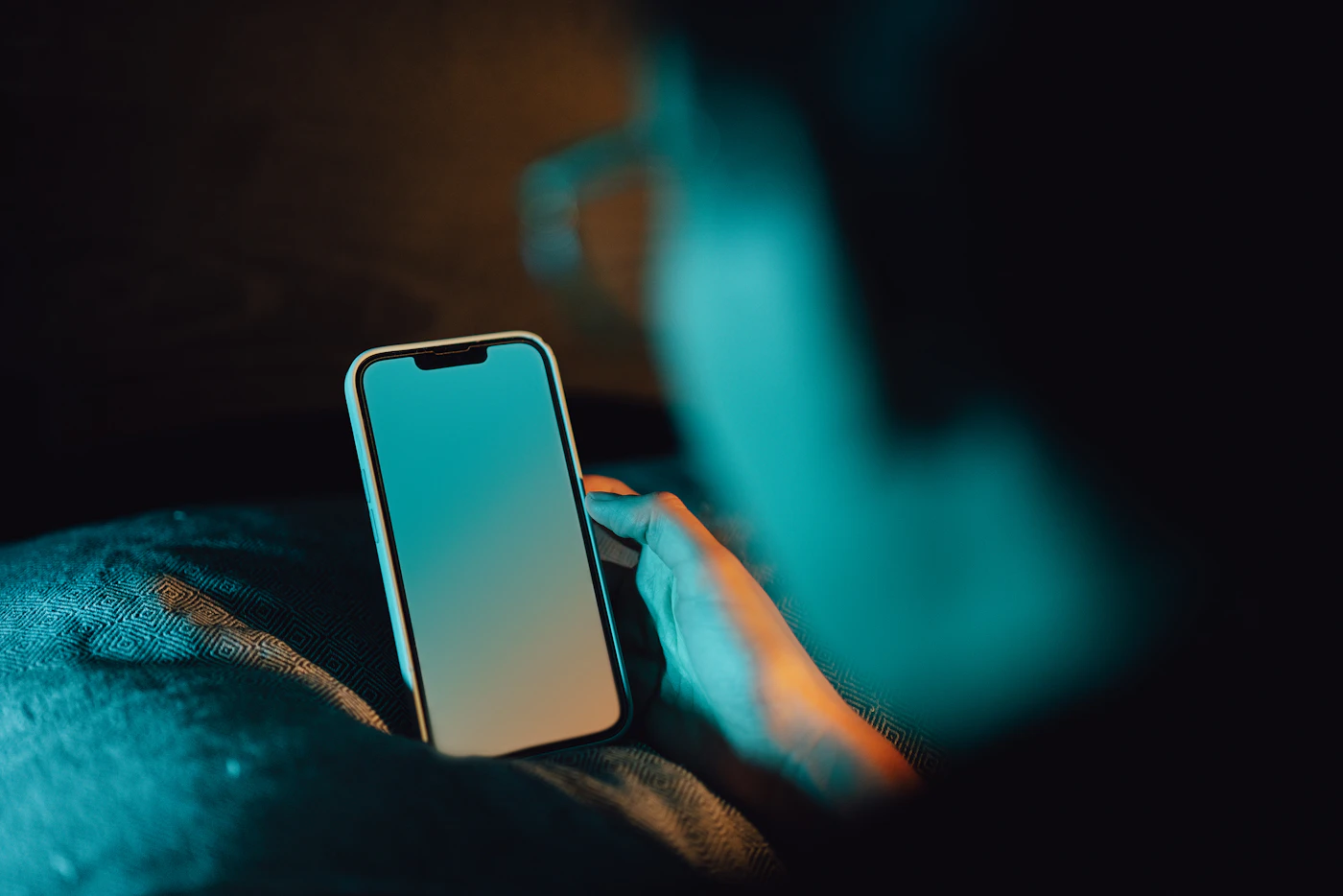 Hand holding a smartphone mid-conversation — a customer replying to a two-way SMS marketing message