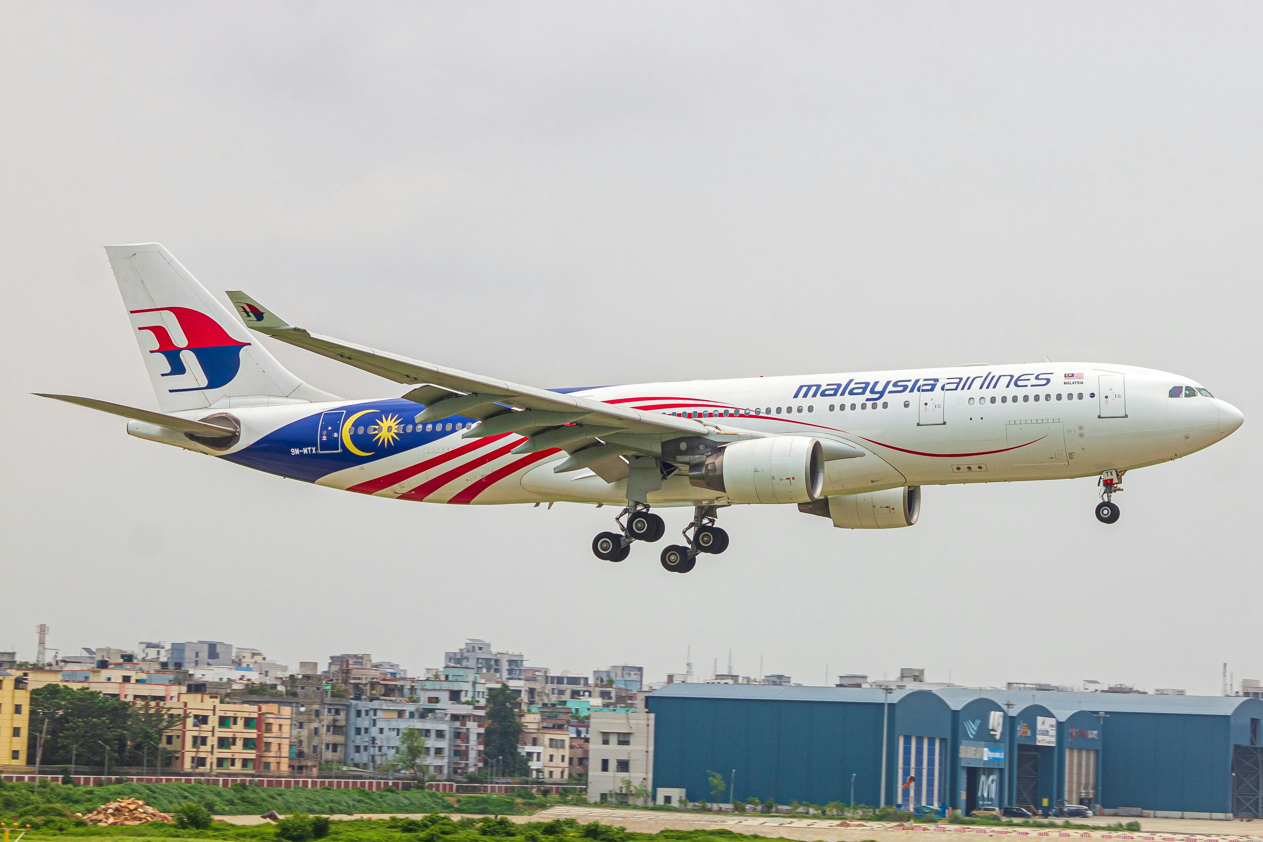 A large jetliner flying through a cloudy sky