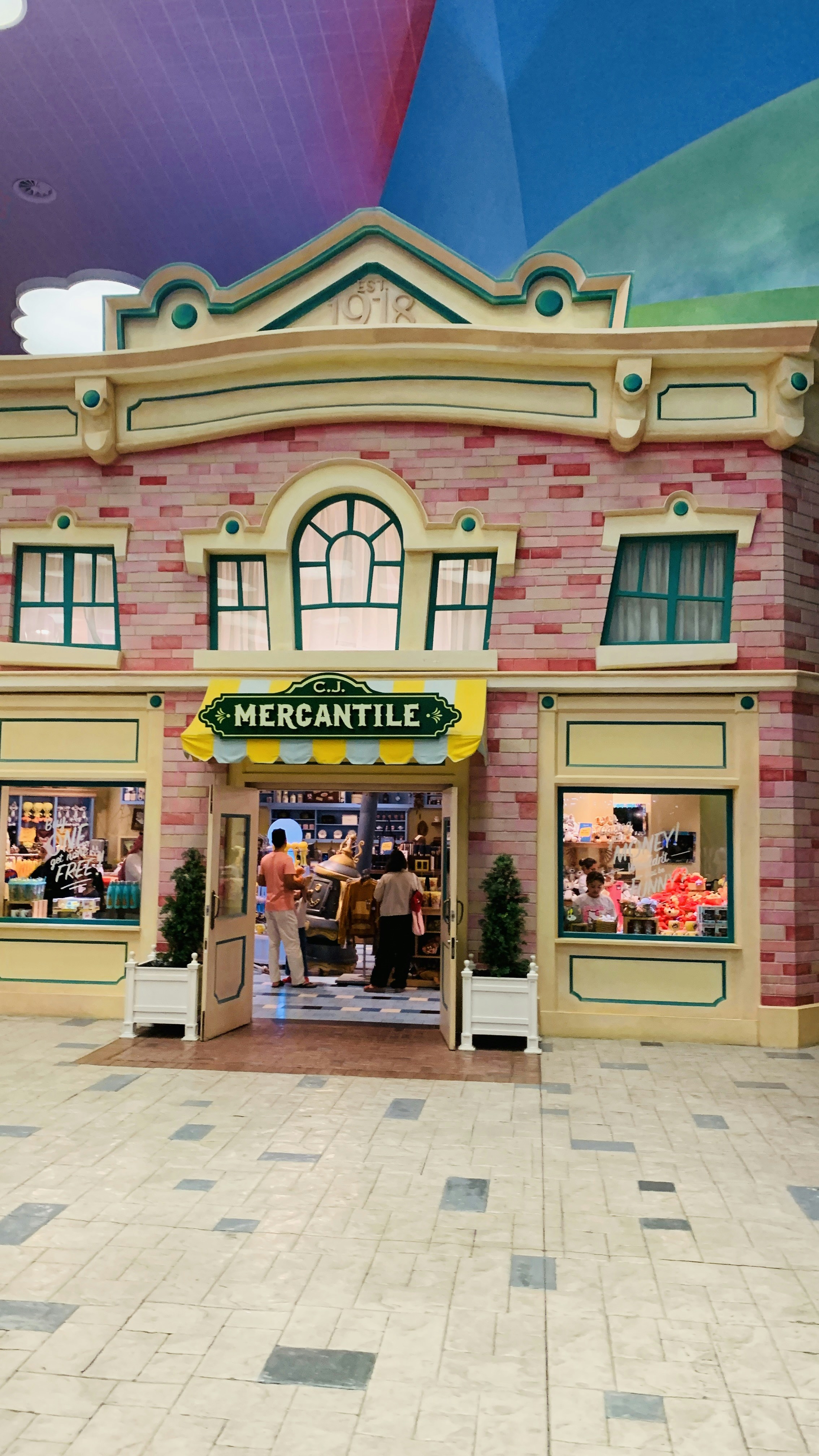 A large brick building with a yellow and green awning