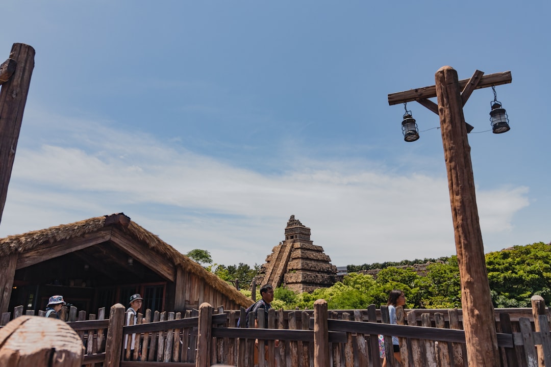 A wooden structure with a bell on top of it,