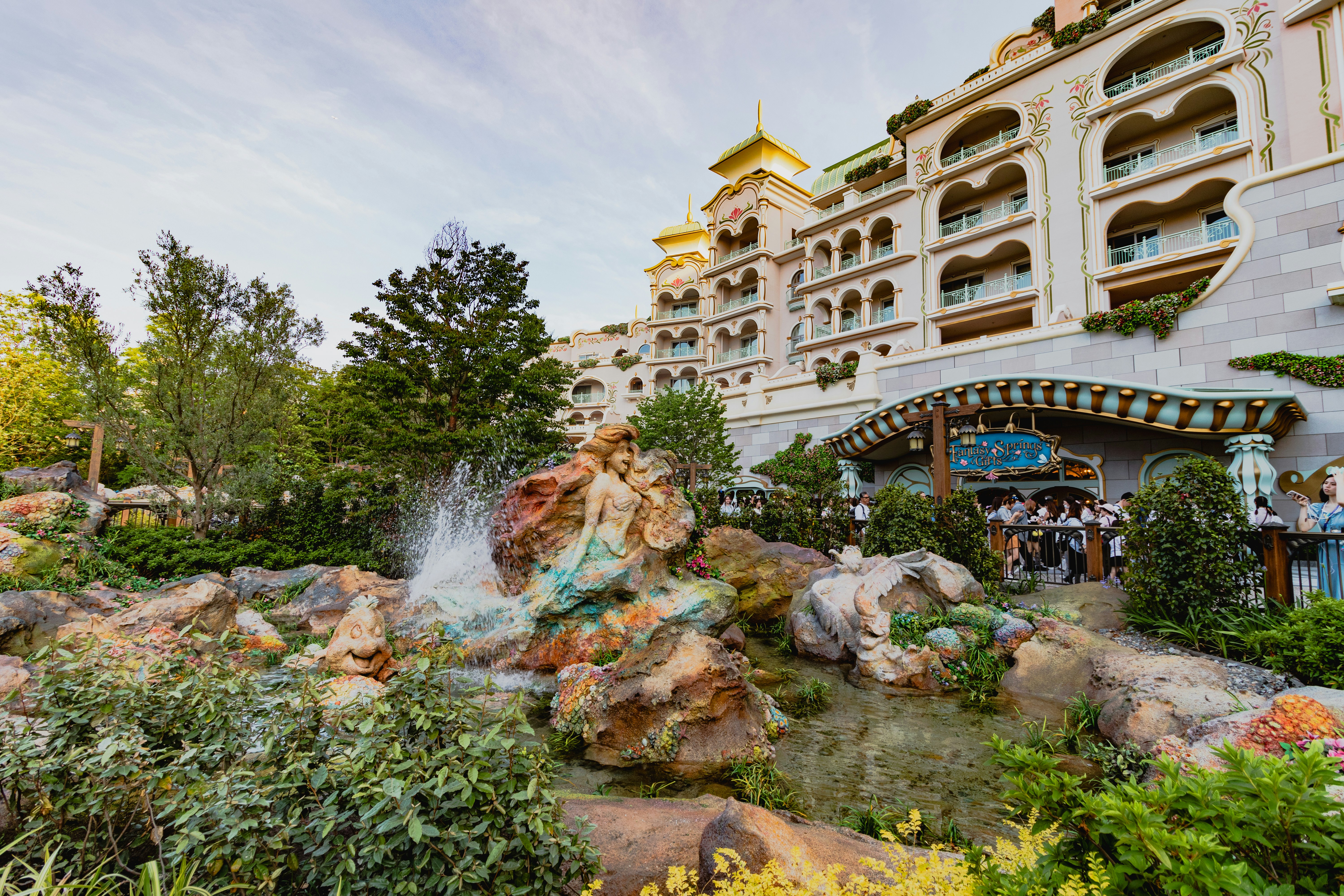 A large building with a waterfall in front of it, 