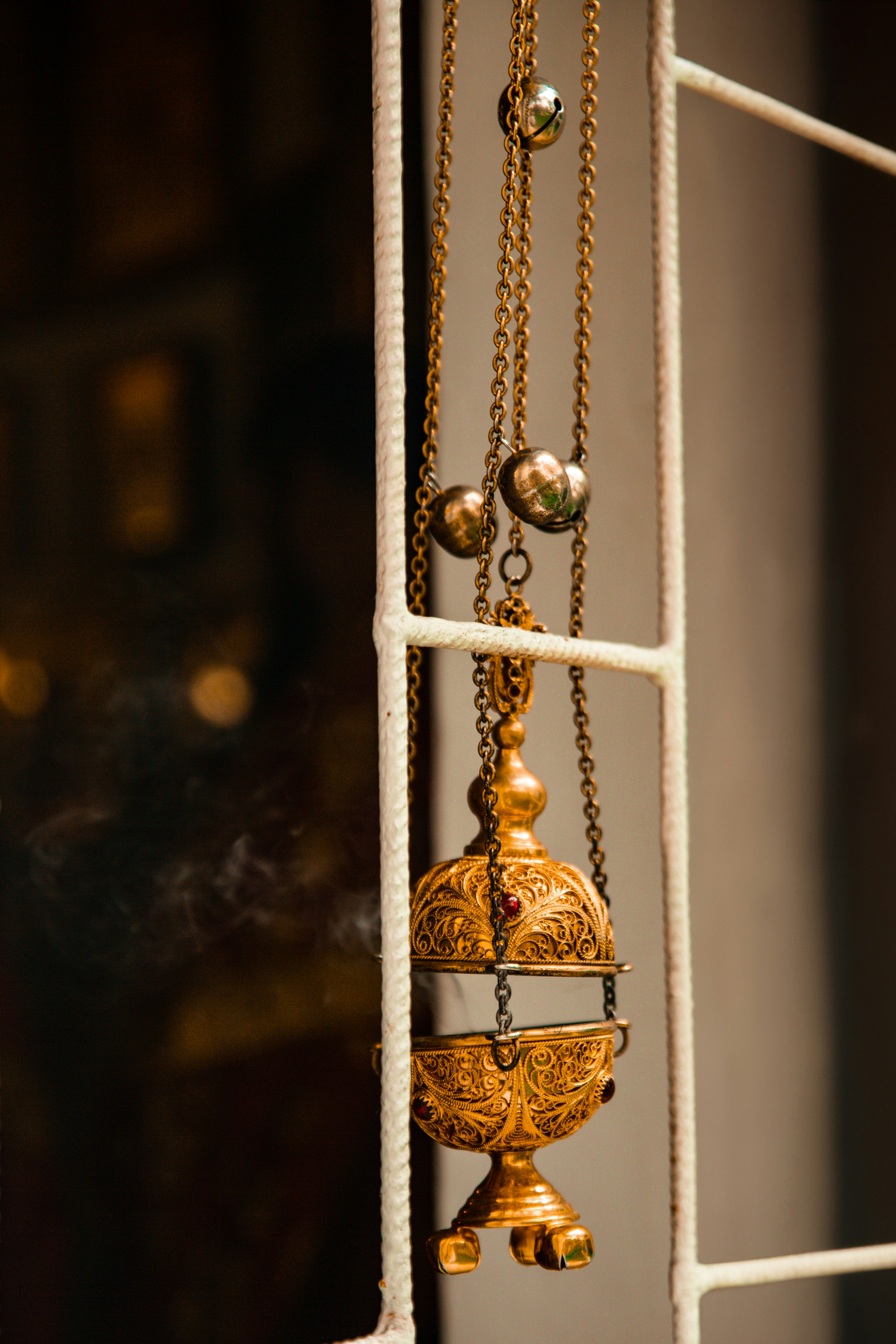 A close up of a window with a chain hanging from it