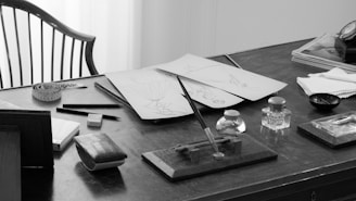 A black and white photo of a desk and chair