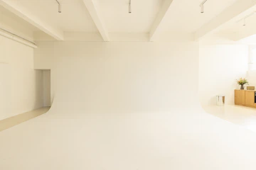 A room with a white wall and a white ceiling