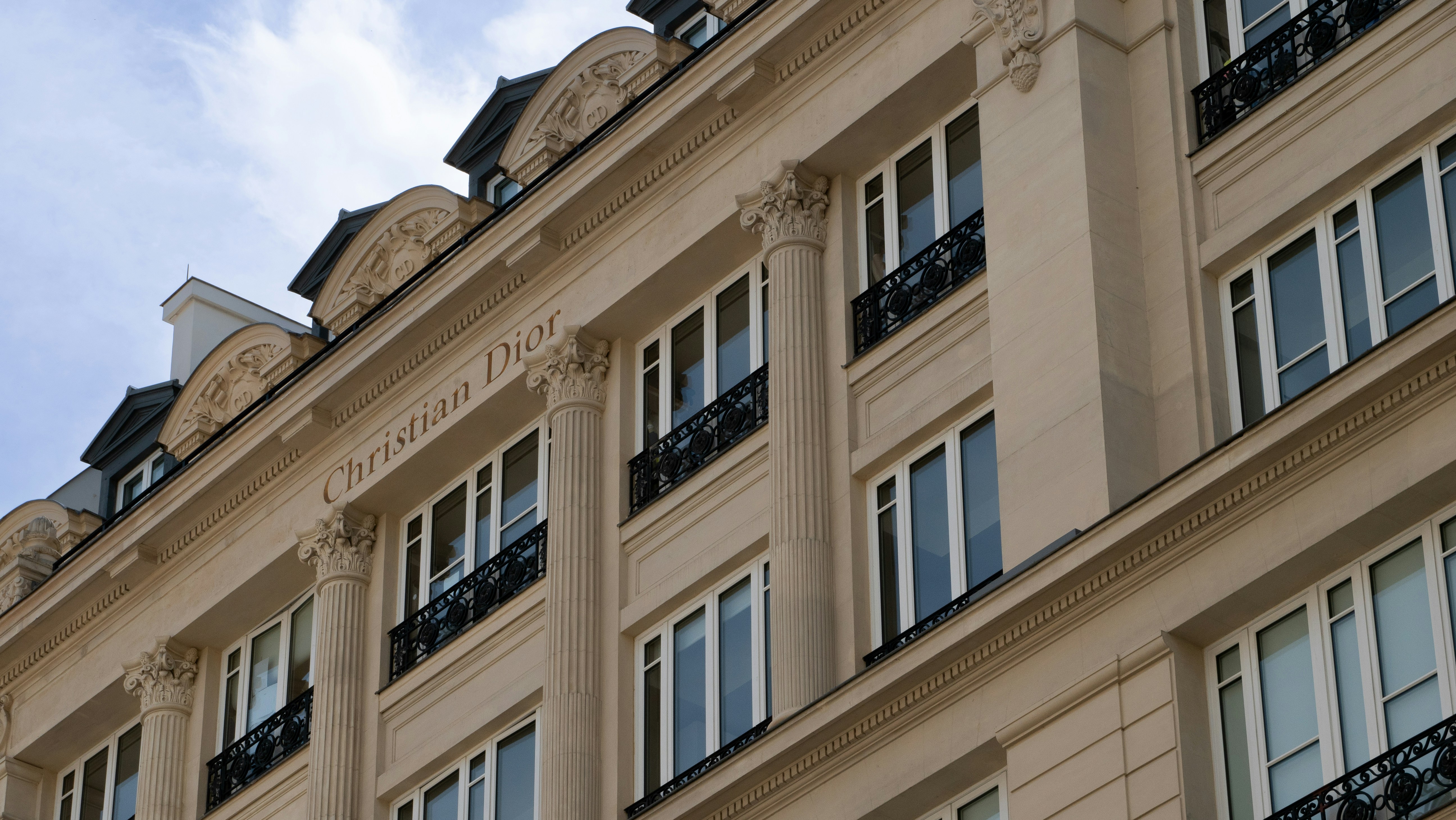 A tall building with many windows and balconies, 