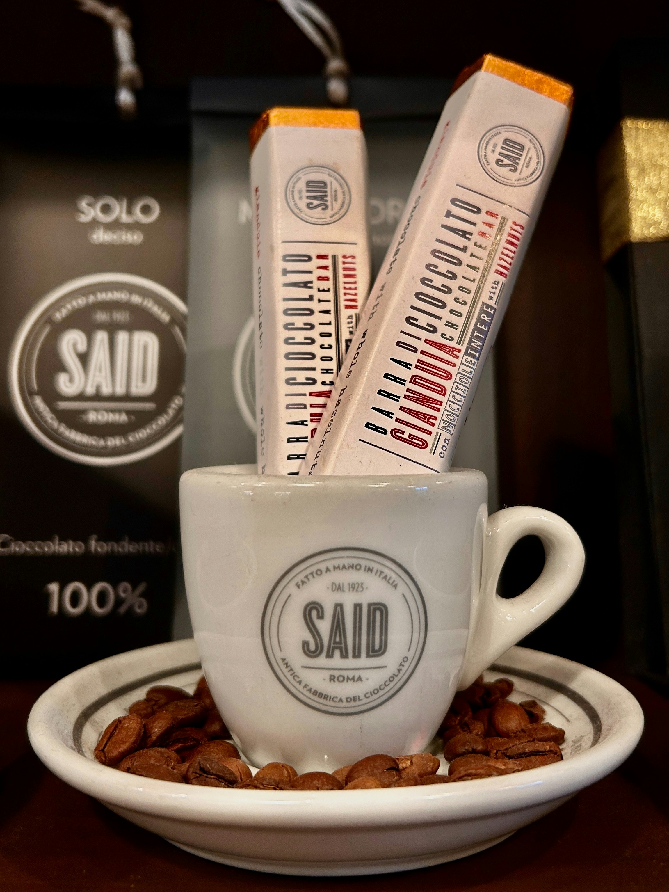 A cup filled with coffee beans sitting on top of a table