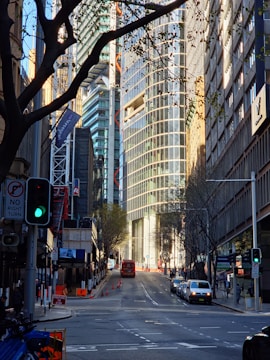 A city street filled with traffic next to tall buildings