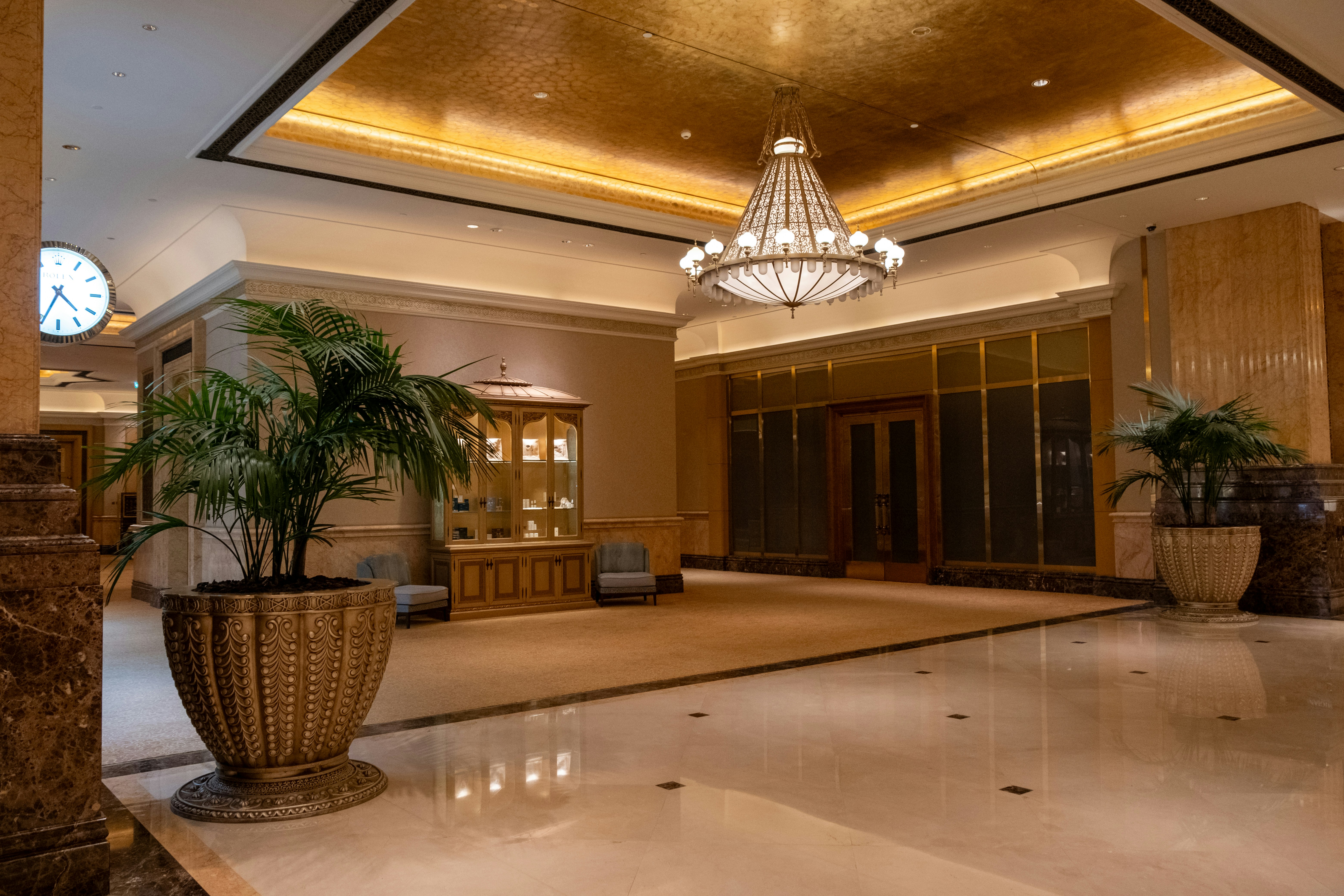Hotel lobby with chandelier and planters