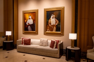 A living room filled with furniture and paintings on the wall