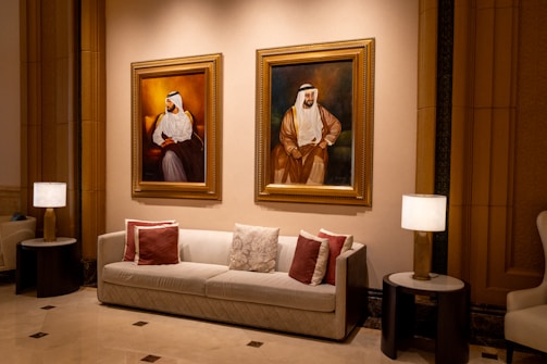 A living room filled with furniture and paintings on the wall