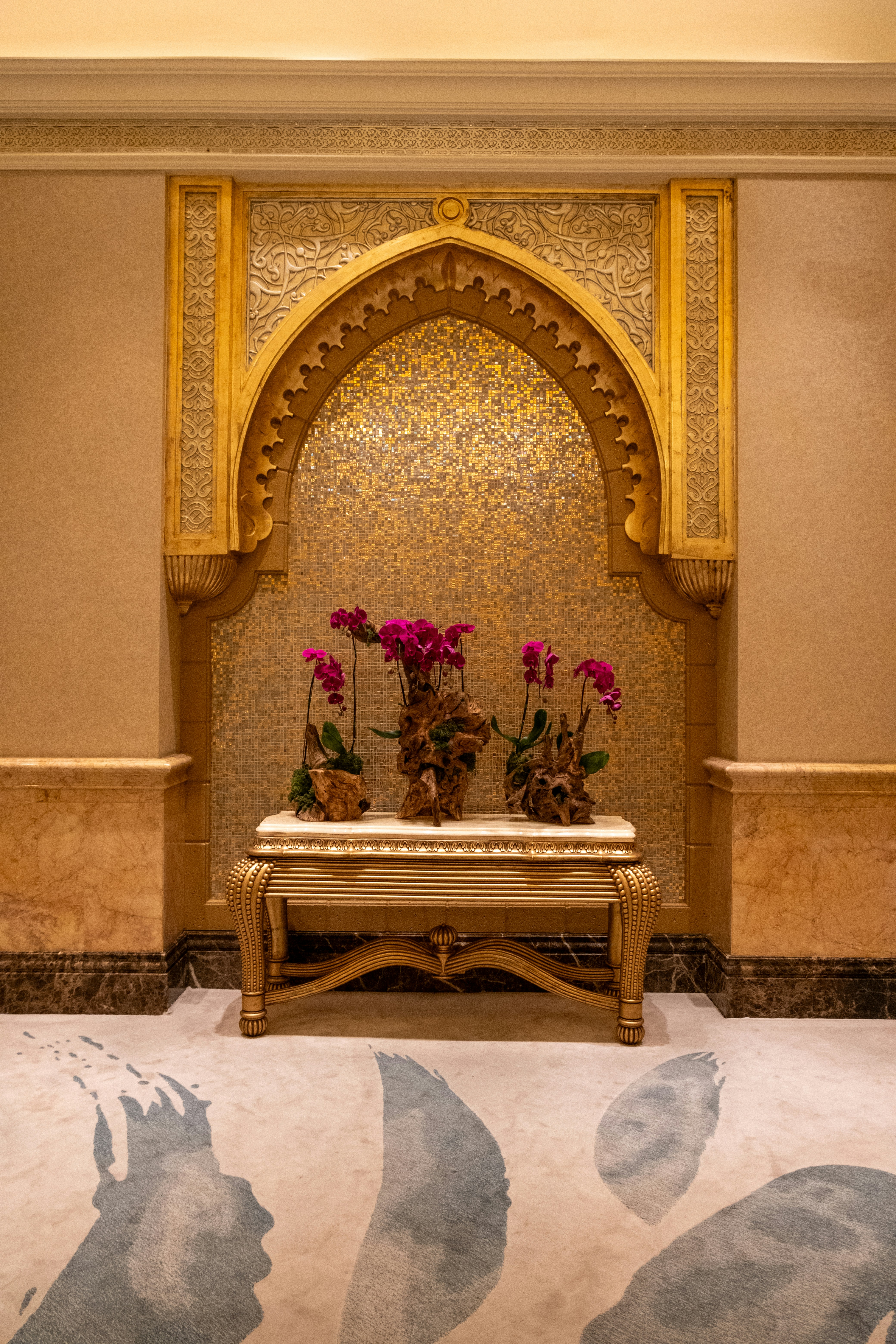 A room with a bench and flowers in it