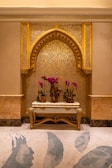 A room with a bench and flowers in it