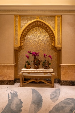A room with a bench and flowers in it
