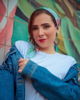 A woman wearing a blue jean jacket and a headband