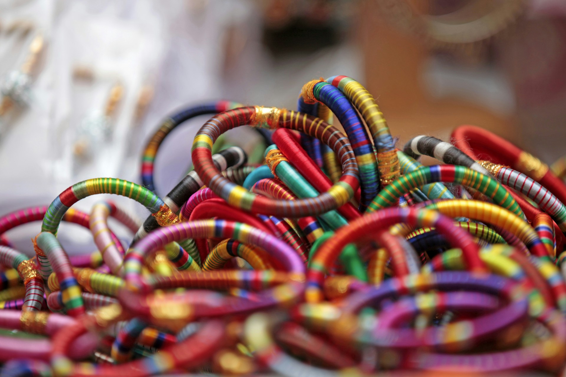 A pile of colorful bracelets sitting on top of a table