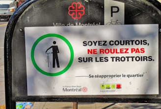 A sign that is on the side of a street