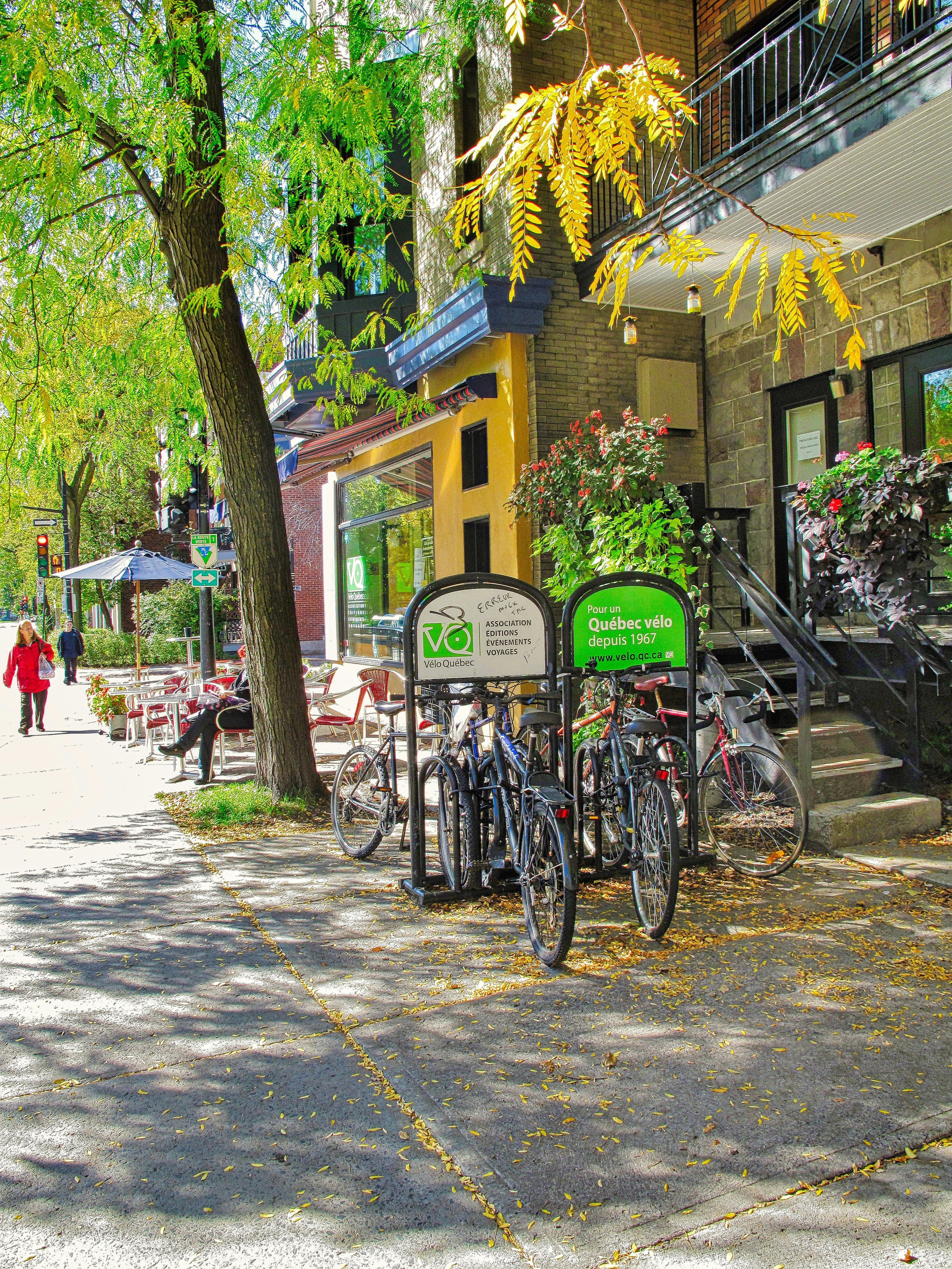 A couple of bikes parked next to each other on a sidewalk
