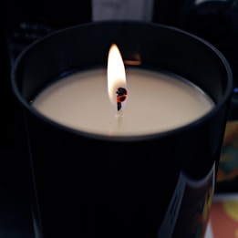 A lit candle sitting on top of a table