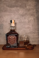 A bottle of whiskey sitting on top of a wooden tray
