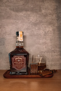 A bottle of whiskey sitting on top of a wooden tray