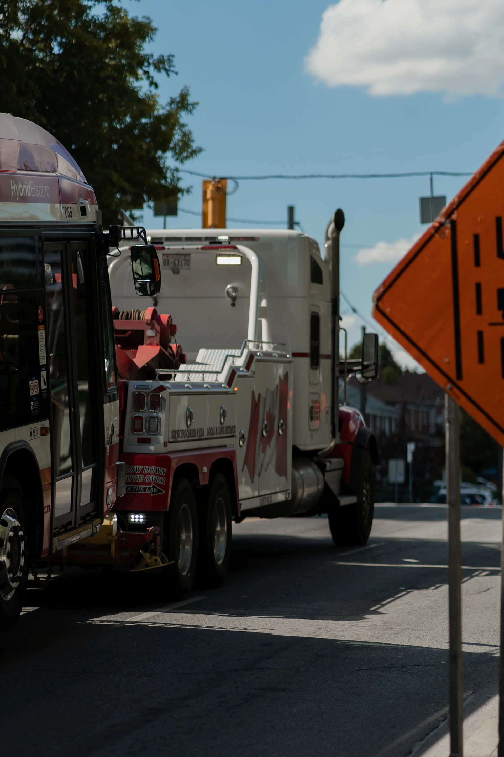 A city bus driving down a street next to a traffic sign