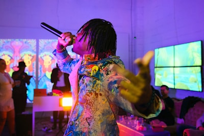 A woman holding a gun in a room full of people